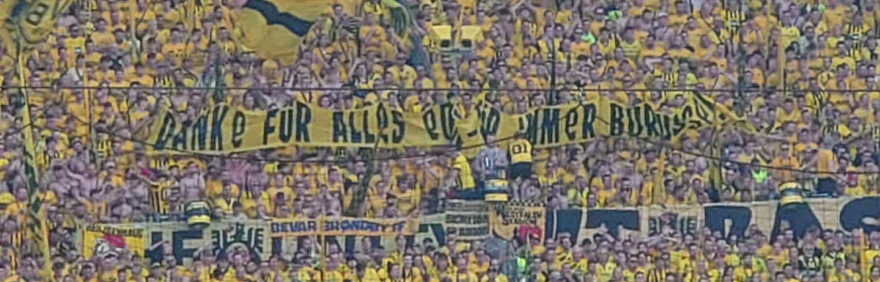 BVB - Eintracht Frankfurt Panorama der vollen gelben Südtribüne mit einem langen Spruchband und Fahnen.